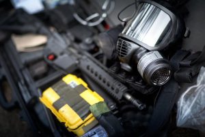 Military essentials including gas mask and weapons.