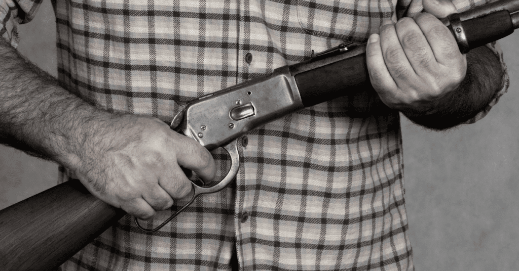 a man holding a rifle