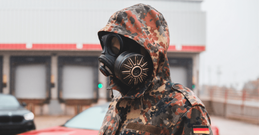 a man wearing a military gas mask with microfans